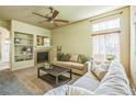 Cozy living room with a fireplace, built-in shelving, and a comfortable sofa at 1404 Tonkin Pl, Longmont, CO 80504