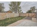 Spacious, fenced backyard with green grass, perfect for outdoor activities and relaxation at 3930 W Kentucky Ave, Denver, CO 80219