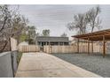 Long driveway leading to a fenced backyard with a covered parking area at 3930 W Kentucky Ave, Denver, CO 80219