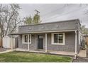 Charming covered front porch with stone accents and white support beams welcomes you home at 3930 W Kentucky Ave, Denver, CO 80219