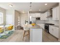 Well-lit kitchen featuring stainless steel appliances and island with pendant lights and barstool seating at 655 Stonebridge Dr, Longmont, CO 80503