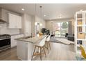 Bright, modern kitchen with stainless steel appliances and a large island with bar seating at 655 Stonebridge Dr, Longmont, CO 80503