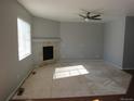 Living room with fireplace and large window providing natural light, ready for new flooring at 25858 E Bayaud Ave, Aurora, CO 80018