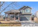 Charming two-story home with a well-manicured lawn and a two-car garage at 291 Las Lomas St, Brighton, CO 80601