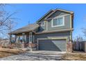 Charming two-story home with a well-manicured lawn and a two-car garage at 291 Las Lomas St, Brighton, CO 80601