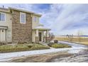 Charming two-story townhouse featuring a covered entryway, brick accents, and low maintenance landscaping at 13001 Grant Cir # C, Thornton, CO 80241