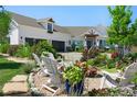 Landscaped front yard with Adirondack chairs, a fire pit, and colorful flower beds at 1935 Bashley Rd, Monument, CO 80132