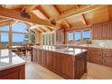 Gourmet kitchen featuring hardwood floors, granite countertops, stainless appliances, and beautiful mountain views at 25803 Aspen Way, Golden, CO 80401