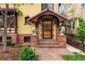 Close-up of the home's entryway, with a brick path and ornate architectural details at 317 N Lafayette St, Denver, CO 80218