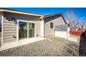 Back exterior featuring a sliding glass door and a small storage shed at 5032 Nighthawk Pkwy, Brighton, CO 80601