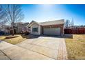 Inviting single-Gathering home with a brick-accented two-car garage and wide driveway at 5032 Nighthawk Pkwy, Brighton, CO 80601