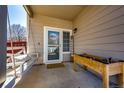 Cozy front porch features a porch swing and a wooden planter box at 5032 Nighthawk Pkwy, Brighton, CO 80601