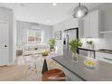 Bright, staged living room featuring wood floors, modern decor, and natural light from a large window at 4232 Jason St # 2, Denver, CO 80211