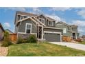Charming two-story home with well-maintained lawn and a two car garage at 643 Ranchhand Dr, Berthoud, CO 80513