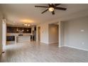 Open-concept living area with modern lighting, ceiling fan and beautiful laminate floors at 643 Ranchhand Dr, Berthoud, CO 80513