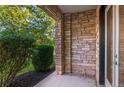 Charming entrance featuring unique stonework, tidy landscaping and a modern glass storm door at 2745 Java Ct, Denver, CO 80211
