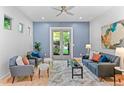 Cozy living room with stylish furniture, neutral colors, bright windows, and an outside view at 2745 Java Ct, Denver, CO 80211