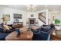 Spacious living room featuring a cozy fireplace, large TV, and comfortable seating area at 14938 Vienna Cir, Parker, CO 80134