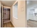 Hallway view leading to a kitchen, highlighting open layout and modern flooring at 1050 N Lafayette St # 101, Denver, CO 80218