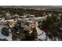 Panoramic view of beautiful modern home in wooded location with city lights visible in the distance at 1803 Avenida Del Sol, Castle Rock, CO 80104