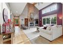Inviting living room boasts high ceilings, a cozy fireplace and plenty of natural light at 5683 Fig Way, Arvada, CO 80002