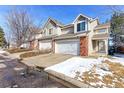 Attractive townhome featuring a two-car garage and brick detailing in a lovely neighborhood at 13068 Harrison Dr, Thornton, CO 80241