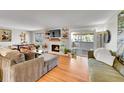 Inviting living room with fireplace, hardwood floors, and sliding door to balcony at 2005 Tabor Dr, Lakewood, CO 80215
