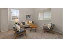 Bright living room with neutral decor and two large windows at 1936 Alpine Dr, Erie, CO 80516