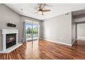 Sunlit living room featuring hardwood floors, a fireplace, and a sliding door leading to a balcony at 3865 S Dayton St # 105, Aurora, CO 80014