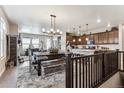 Inviting dining area featuring a rustic wood table and bench with a cozy rug, adjacent to the modern kitchen at 2012 Sagerock Dr, Castle Pines, CO 80108