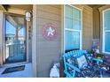 Cozy front porch with a welcoming sign, comfortable bench, and stylish decor creating a warm atmosphere at 2012 Sagerock Dr, Castle Pines, CO 80108