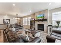 Cozy living room features a fireplace, rustic coffee table, and comfortable leather seating at 2012 Sagerock Dr, Castle Pines, CO 80108