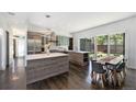 Bright, open kitchen with a large island, stainless steel appliances, and hardwood floors at 3057 S University Cir, Englewood, CO 80113