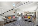Spacious living room with high ceilings, a staircase, and a view of the backyard at 3057 S University Cir, Englewood, CO 80113