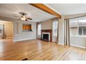 Open-concept living room featuring hardwood floors, fireplace, and beam at 1456 Wabash St, Denver, CO 80220