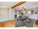 Bright living room featuring hardwood floors, ceiling fan, and neutral décor at 1456 Wabash St, Denver, CO 80220