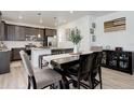 Stylish dining room with modern lighting, wood floors, and an open layout to the kitchen area at 1256 Elbridge Dr, Elizabeth, CO 80107