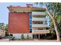 Brick and white exterior shows balconies on the building at 937 Clarkson St # 101, Denver, CO 80218