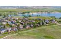 Panoramic aerial view of a residential neighborhood with a lake and lush greenery at 26741 E Arbor Dr, Aurora, CO 80016