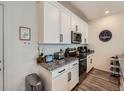 Well-lit kitchen featuring granite countertops, stainless steel appliances, and ample cabinet space at 17991 E 103Rd Ave, Commerce City, CO 80022
