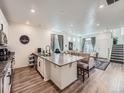 Open-concept kitchen with granite countertops, white cabinets, and view of the living room at 17991 E 103Rd Ave, Commerce City, CO 80022