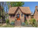 Charming brick home with a cozy front porch and landscaped yard, perfect for enjoying peaceful evenings at 1601 Albion St, Denver, CO 80220