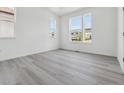 Inviting bedroom with large windows offering ample natural light and neutral gray toned flooring at 25273 E Warren Pl, Aurora, CO 80018