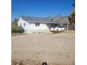 View of a charming home featuring a carport and ample parking on a gravel drive at 254 Donna St, Fort Lupton, CO 80621