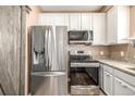 Modern kitchen with stainless steel appliances and a farmhouse sink at 6837 S Webster St # C, Littleton, CO 80128