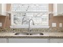 Modern kitchen sink with granite countertop and window at 6837 S Webster St # C, Littleton, CO 80128