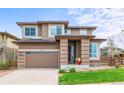 Beautiful two-story home featuring a brick facade, a two-car garage, and well-manicured lawn at 9570 Kendrick Way, Arvada, CO 80007