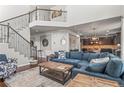 Spacious living room boasts an open floor plan, staircase, and flows into kitchen, perfect for entertaining at 9570 Kendrick Way, Arvada, CO 80007
