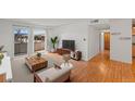 Bright living room featuring hardwood floors, a sliding glass door to the balcony, and modern furnishings at 5102 Williams Fork Trl # 201, Boulder, CO 80301