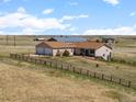 A well-maintained ranch home on a sprawling lot, featuring an attached garage and ample outdoor space at 13640 County Road 182, Bennett, CO 80102